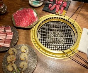 korean bbq grill with assorted meats to be cooked